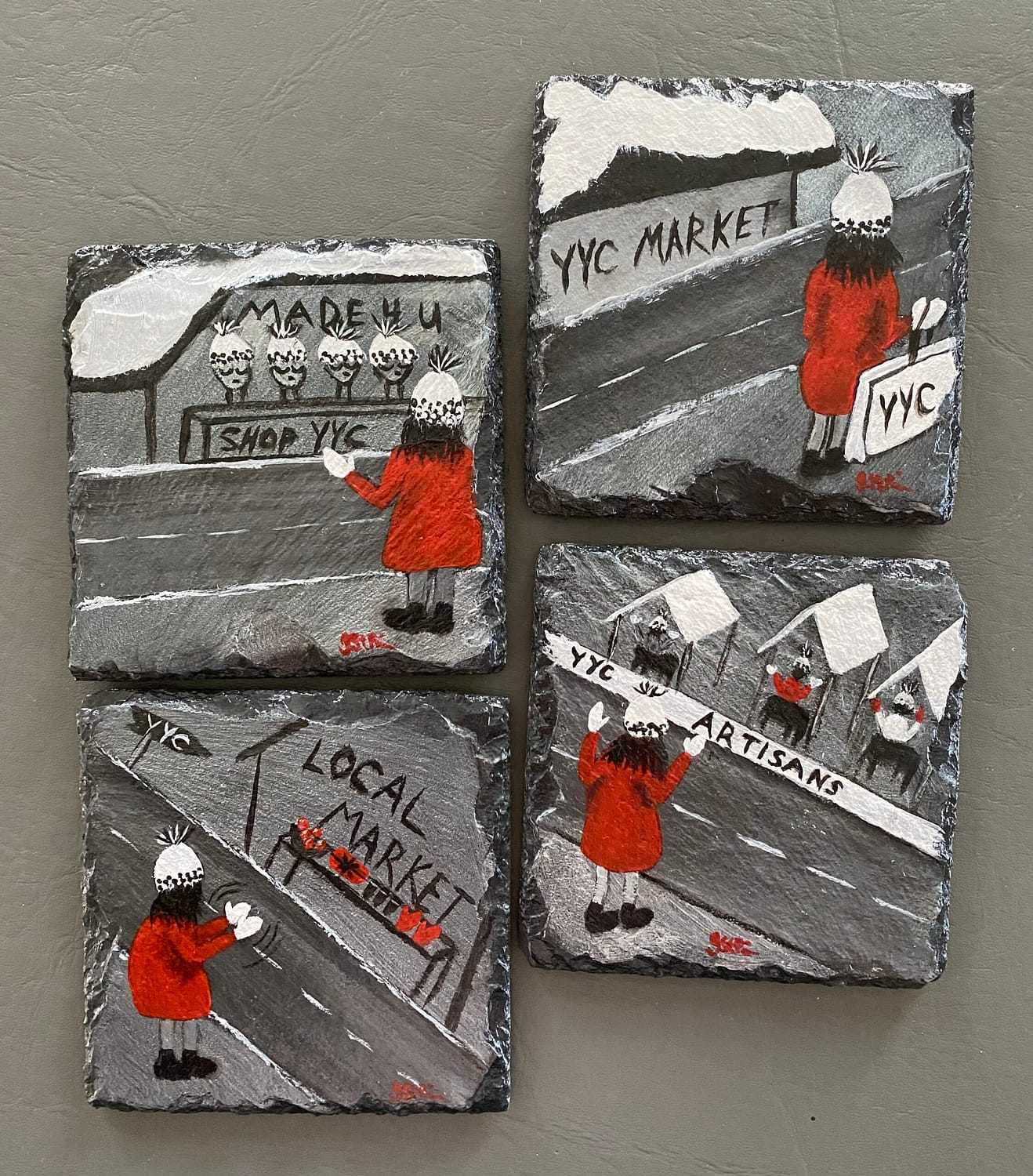 A photo of 4 slate coasters painted with a girl shopping at Calgary markets