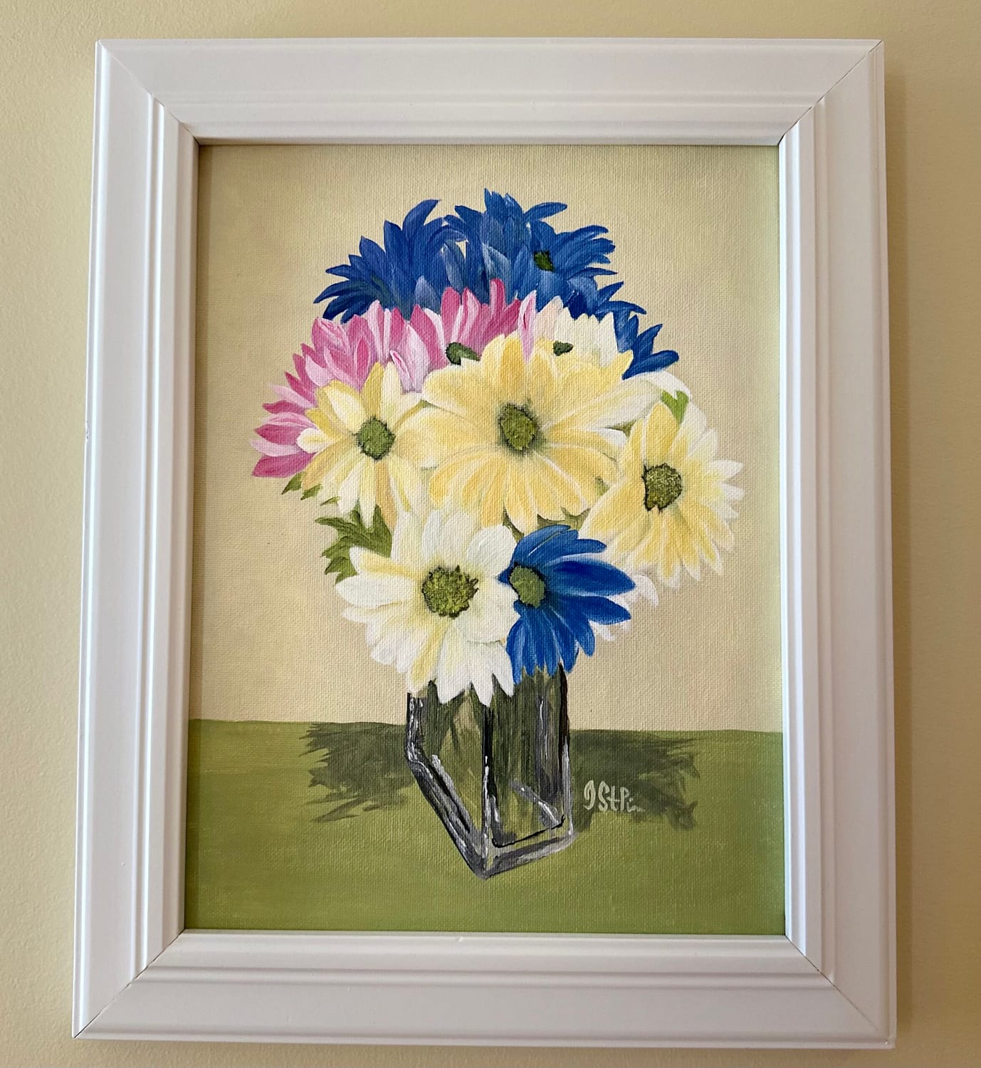 A painting of brightly coloured daisies in a clear rectangular vase