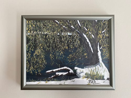 A painting of a snow covered tree at the edge of water