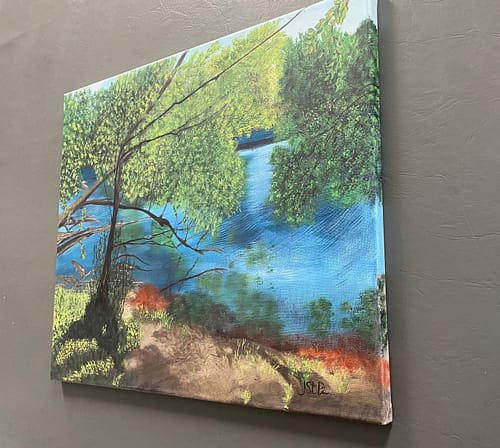 A very bright painting of a pond and trees on the edge