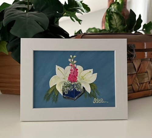 A painting of white lilies in a blue glass vase in a white frame