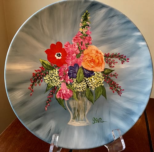 A beautiful painting of mixed flowers on a 10.5" plate