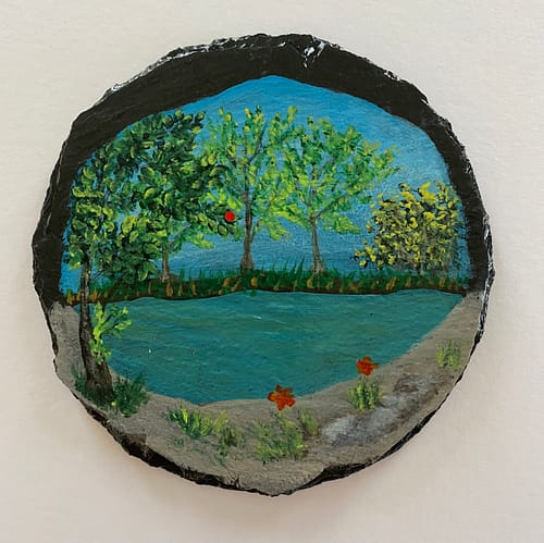 Coaster painted with an image of a pond and trees