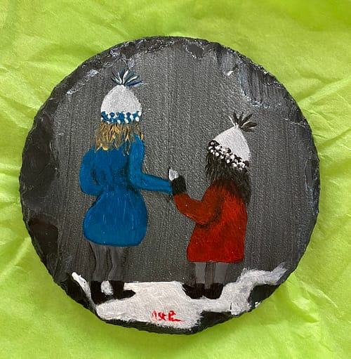 Coaster with a painting of a girl and her sister outside in the snow