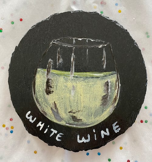 Coaster painted with a glass of white wine on it