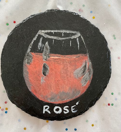 Coaster painted with a glass of rose wine on it