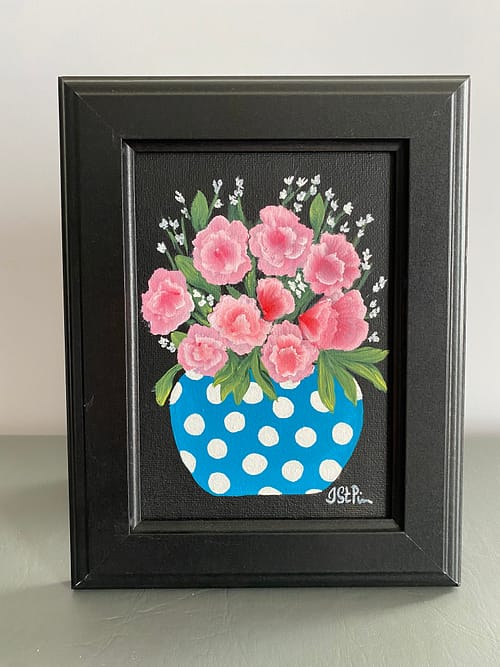 Painting of pink mini carnations in a blue and white polka dot pot